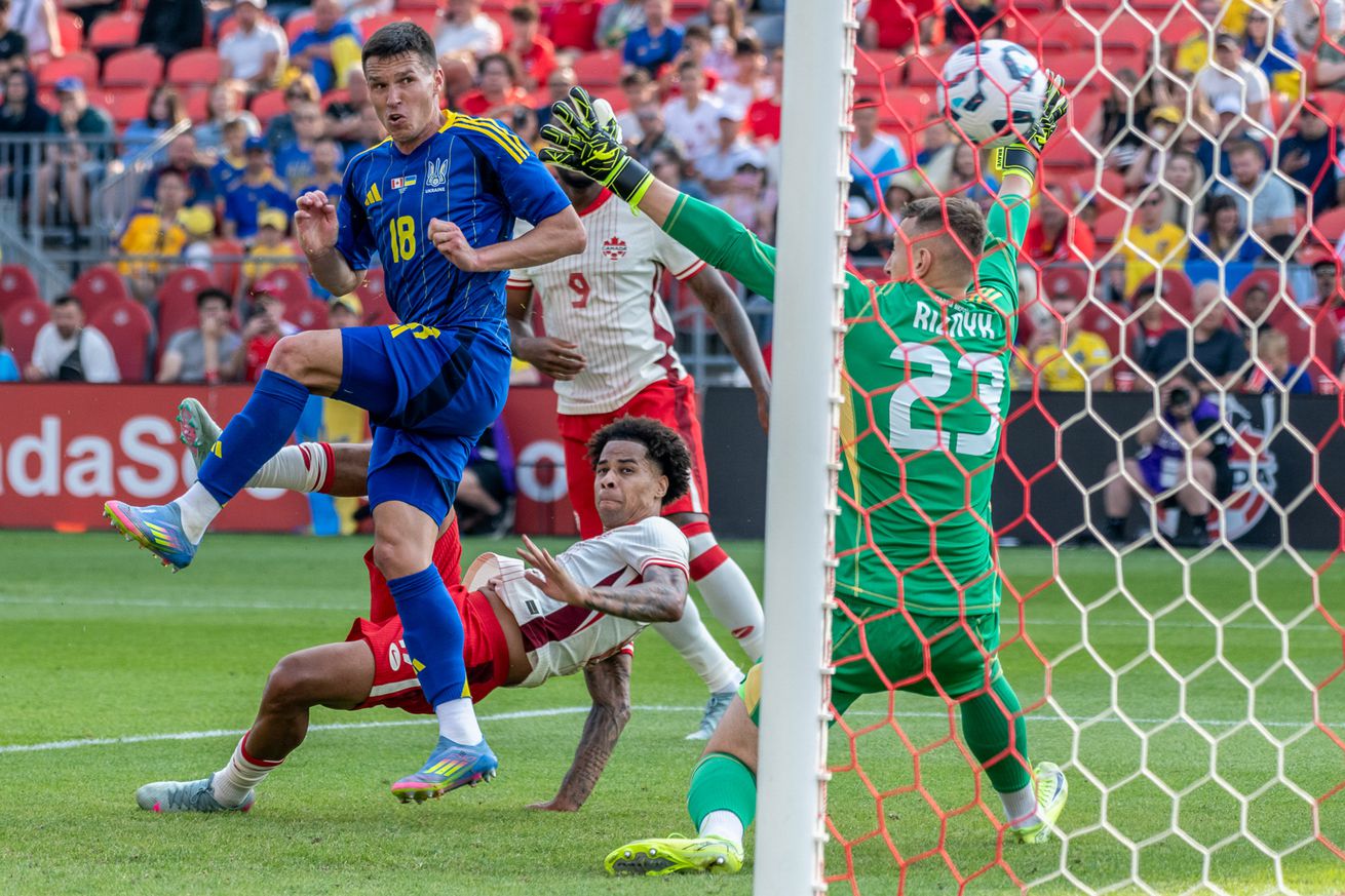Tajon Buchanan #17 of Canada scores a goal against Dmytro...
